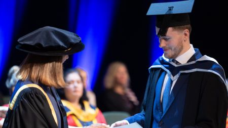 NCI graduate receiving certificate